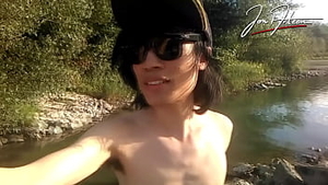 Jon Arteen is this slim Asian twink boy dancing a musical strip-tease on the river smiling showing h Thumb